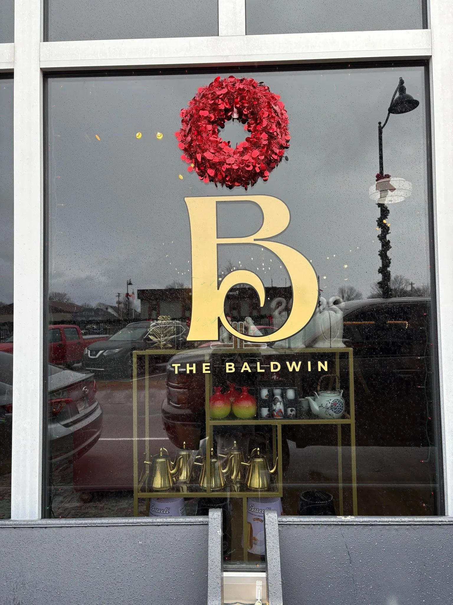 The Baldwin gold B monogram and wordmark on the storefront window at 23 N Baldwin St in Bargersville, Indiana
